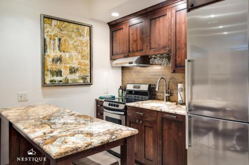 a kitchen with wooden cabinets and a stainless steel refrigerator at LMV A-107 in Park City