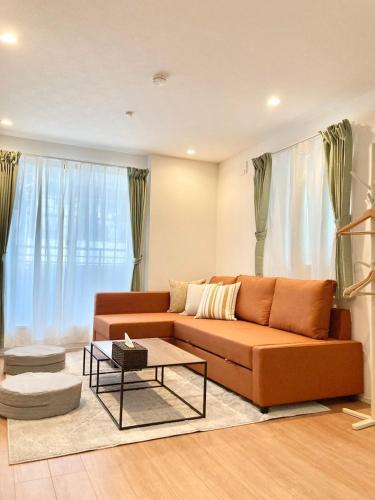 a living room with a couch and a table at Casa Stella 17 by Liaison in Osaka
