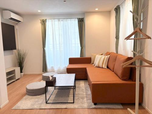 a living room with a couch and a coffee table at Casa Stella 17 by Liaison in Osaka