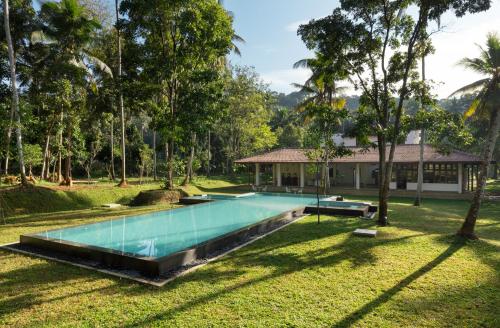an image of a swimming pool in front of a house at Jetwing Wahawa Walauwa, A Luxury Reserve in Rambukkana