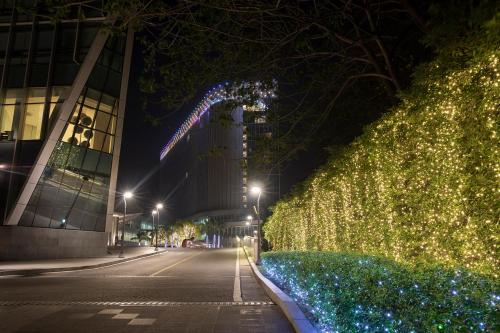a street decorated with christmas lights at night at LOTTE Hotel Yangon in Yangon