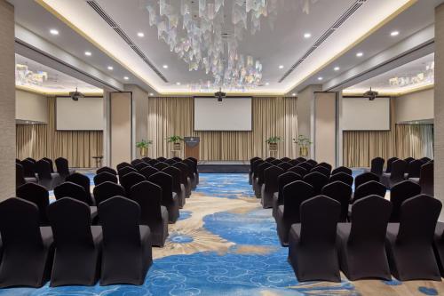 an empty conference room with chairs and screens at Grand Westside Manila Bay in Manila