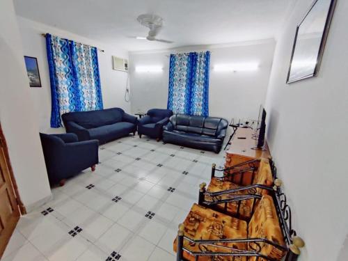 a living room with two blue couches at 4BHK Hilltop Villa with Private Pool Near Candolim in Nerul