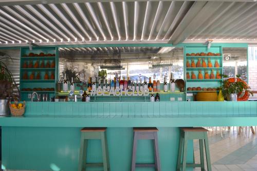 a blue bar with stools in a restaurant at Watsons Bay Boutique Hotel in Sydney