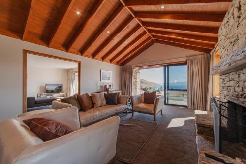 a living room with a couch and a fireplace at Lake Lodge Tekapo in Lake Tekapo