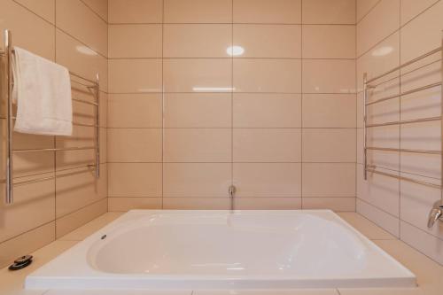 a white tub in a bathroom with a shower at Lake Lodge Tekapo in Lake Tekapo