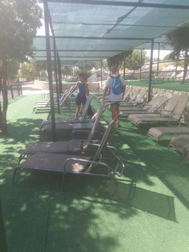 two people walking on a treadmill at a park at Apartments Pravica Trebinje in Trebinje