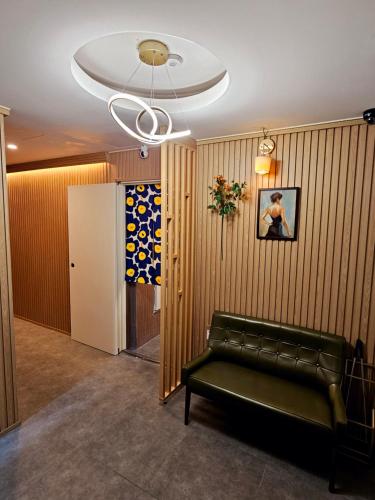 a living room with a couch and a ceiling at Space Stay in Seoul