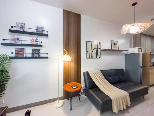a living room with a couch and a table at GemstoneBR in SMDC Coast Residences in Manila