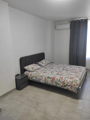 a bed sitting in a room with a bed sidx sidx sidx at Апартаменти Люкс 5 in Khmelnytskyi