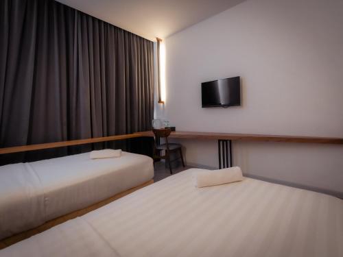 Postel nebo postele na pokoji v ubytování T+ PREMIUM HOTEL