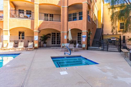 a building with a swimming pool in front of a building at Mountain View #912 Surprise in Surprise