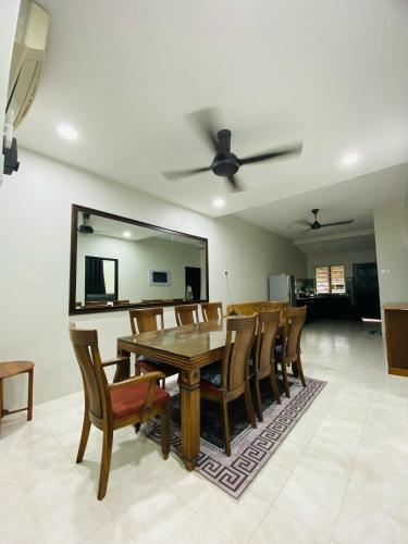 a dining room with a table and chairs at Arissa HomeStay in Kampong Bukit Katil