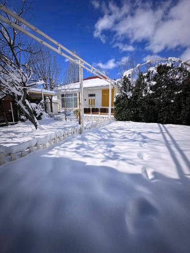 a snow covered driveway in front of a house at Qafqaz Fountain House in Gabala
