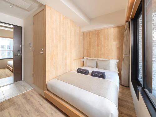 Postel nebo postele na pokoji v ubytování Sakura Cross Hotel Akihabara