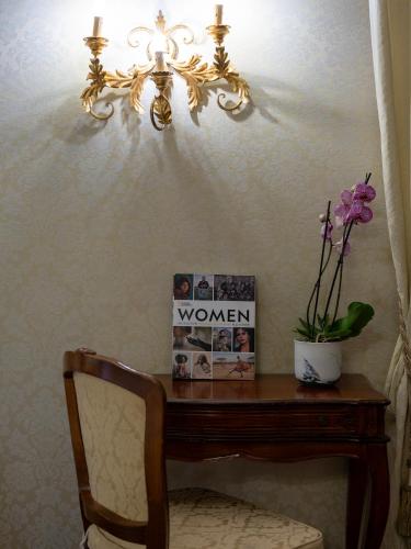 a room with a wooden table and a chandelier at Hotel Antico Doge - a Member of Elizabeth Hotel Group in Venice