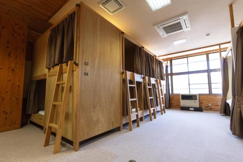 a row of bunk beds in a room at 馬籠ふるさと学校 Magome Furusato Gakkou in Nakatsugawa
