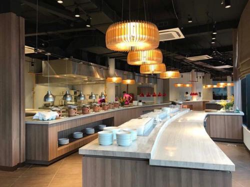 a large kitchen with blue dishes on a counter at Oceanami Villas & Beach Club - Managed by Thang Long Group in Long Hai