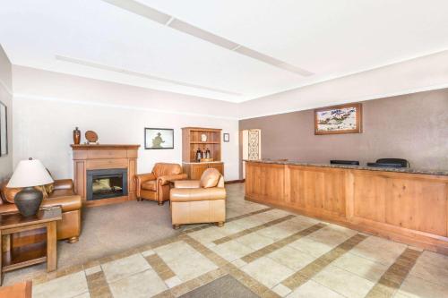 a living room with a fireplace and a waiting area at Super 8 by Wyndham Salina/Scenic Hills Area in Salina
