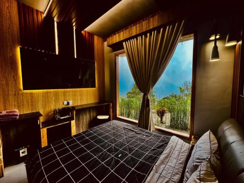 una camera da letto con un letto e una grande finestra di Sky View Bromo Guest House a Ngadisari