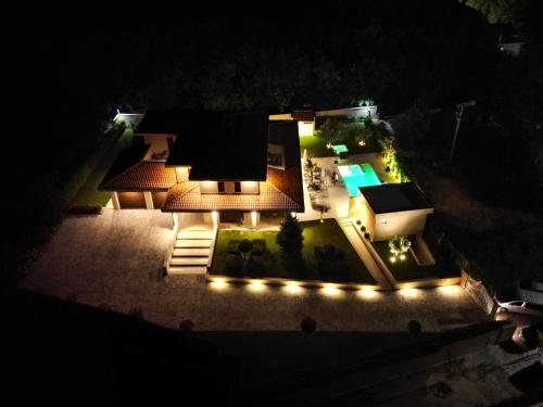 an aerial view of a backyard at night with lights at Villa Dolce Vita in Međugorje