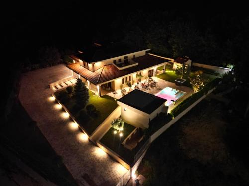 an aerial view of a house at night with lights at Villa Dolce Vita in Međugorje