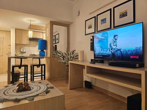a living room with a large flat screen tv at Executive studio appartment in Ghaziabad