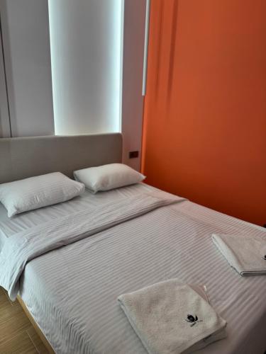 a bed with two pillows and a towel on it at Aygestan plaza in Yerevan