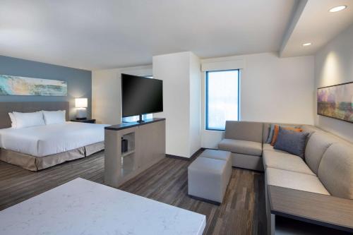 a hotel room with a bed and a couch at Hyatt House Lewes Rehoboth Beach in Lewes