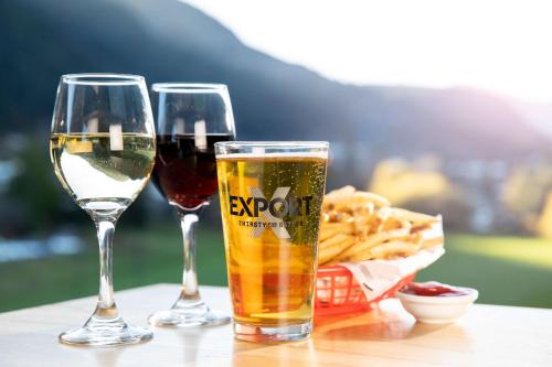 two glasses of wine and french fries on a table at LyLo Queenstown in Queenstown