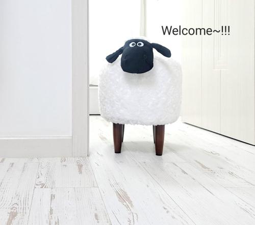 a stuffed sheep standing in a room at HaengGung MaSil in Suwon