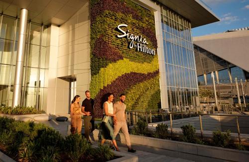 a group of people walking in front of a building at Signia By Hilton Atlanta Georgia World Congress Center in Atlanta