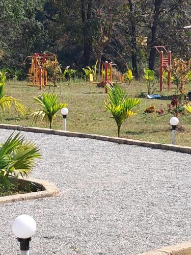 a park with a playground with at Cheetah Farms Jungle Stay in Dandeli