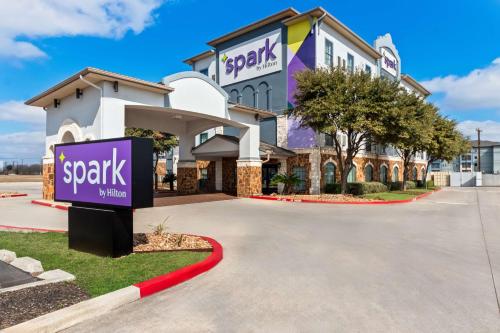 a hotel with a sign in front of a building at Spark By Hilton San Antonio Near Seaworld in San Antonio