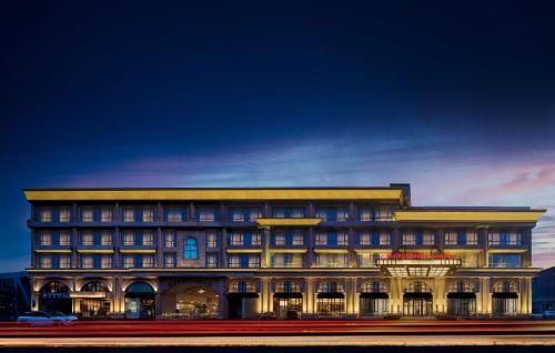 a large building with a lot of windows at Hilton Garden Inn Beijing Guomao in Beijing