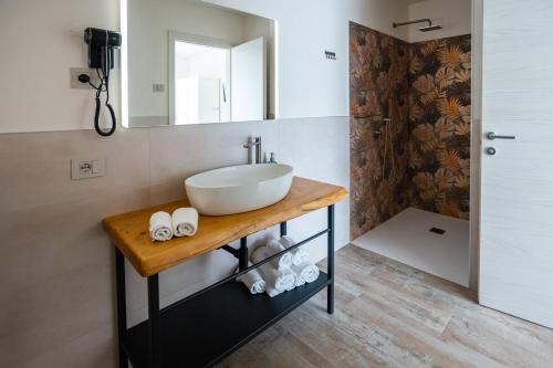 a bathroom with a sink and a mirror at Al Casale - Guest House in Sambruson