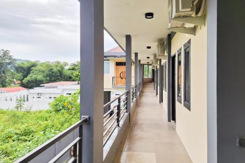 a corridor of a house with a balcony at RedDoorz at Imanuel Homestay Tomohon in Tomohon