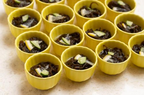 a group of small yellow cups filled with food at Sun Days Kagoshima in Kagoshima