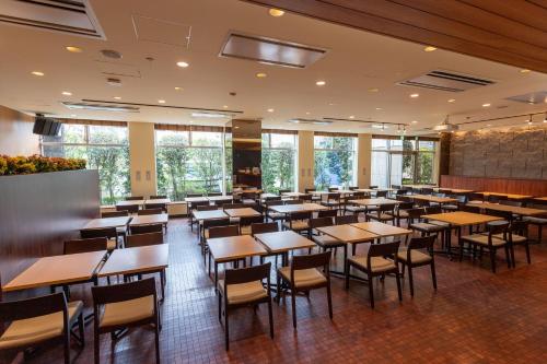 a dining room filled with tables and chairs at Sun Days Kagoshima in Kagoshima