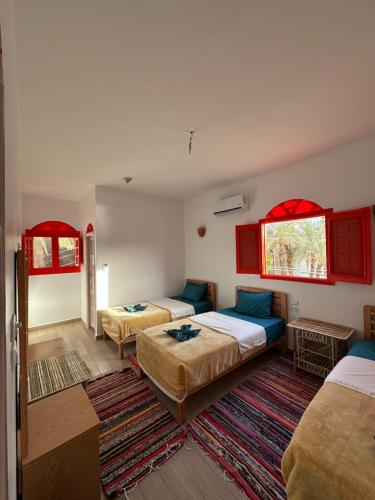 Postel nebo postele na pokoji v ubytování Palm Geust House