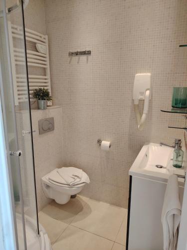 a bathroom with a toilet and a sink at Le Village Montmartre by Hiphophostels in Paris