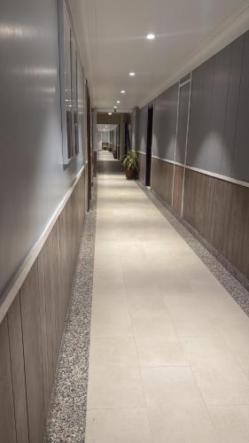 a hallway of an office building with a long corridor at Luxury Aloha Majestic Apartments in Rishīkesh