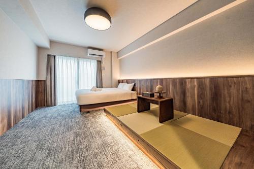 a hotel room with a bed and a window at Apartment Hotel 11 Kuromon 4 in Osaka