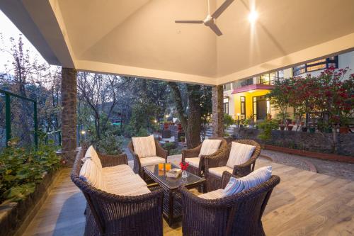 a patio with wicker chairs and a table at Alaya Stays Thistle House - 4 BHK Hideaway with Gazebo & Terrace in Bhīm Tāl