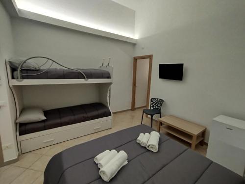 a bedroom with two bunk beds and a chair at Dimora Nonno Mimì in Bitetto