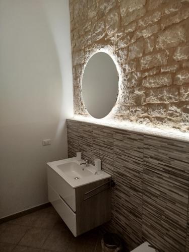 a bathroom with a sink and a mirror at Dimora Nonno Mimì in Bitetto