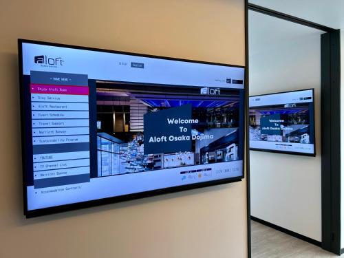 a flat screen tv hanging on a wall at Aloft Osaka Dojima in Osaka