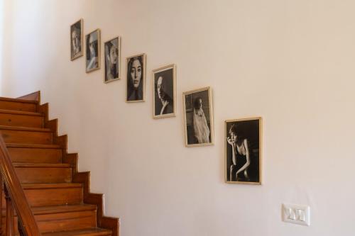 a group of pictures hanging on a wall at Alaya Stays Thistle House - 4 BHK Hideaway with Gazebo & Terrace in Bhīm Tāl