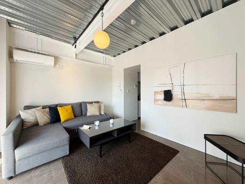a living room with a couch and a table at b hotel Komachi - 1 BR Apartment Free Breakfast Included in Hiroshima