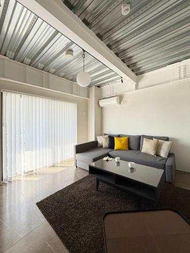 a living room with a couch and a coffee table at b hotel Komachi - 1 BR Apartment Free Breakfast Included in Hiroshima